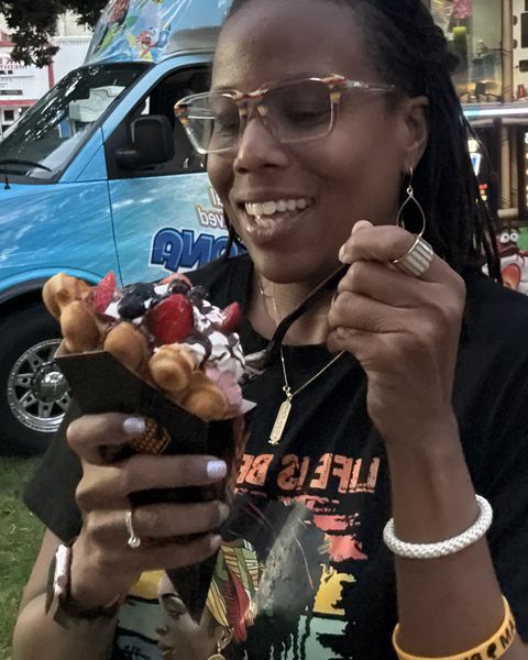 La Wanda tasting a bubble waffle sundae at a food truck