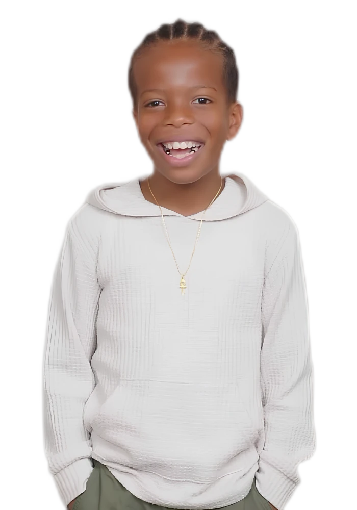 Zaccai laughing in a cream hoodie with an ankh pendant